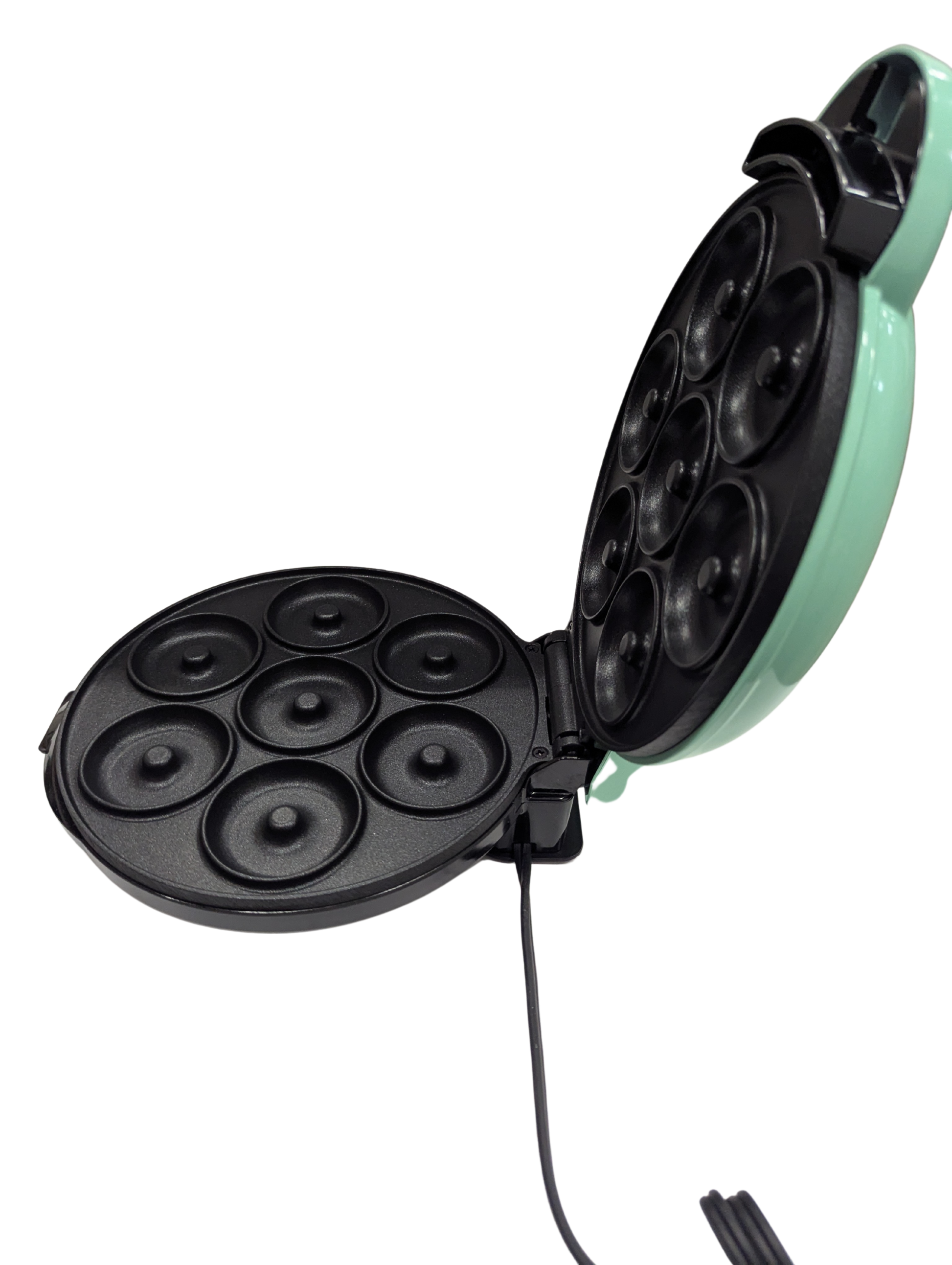 Mint green and black electric mini muffin maker on a white background