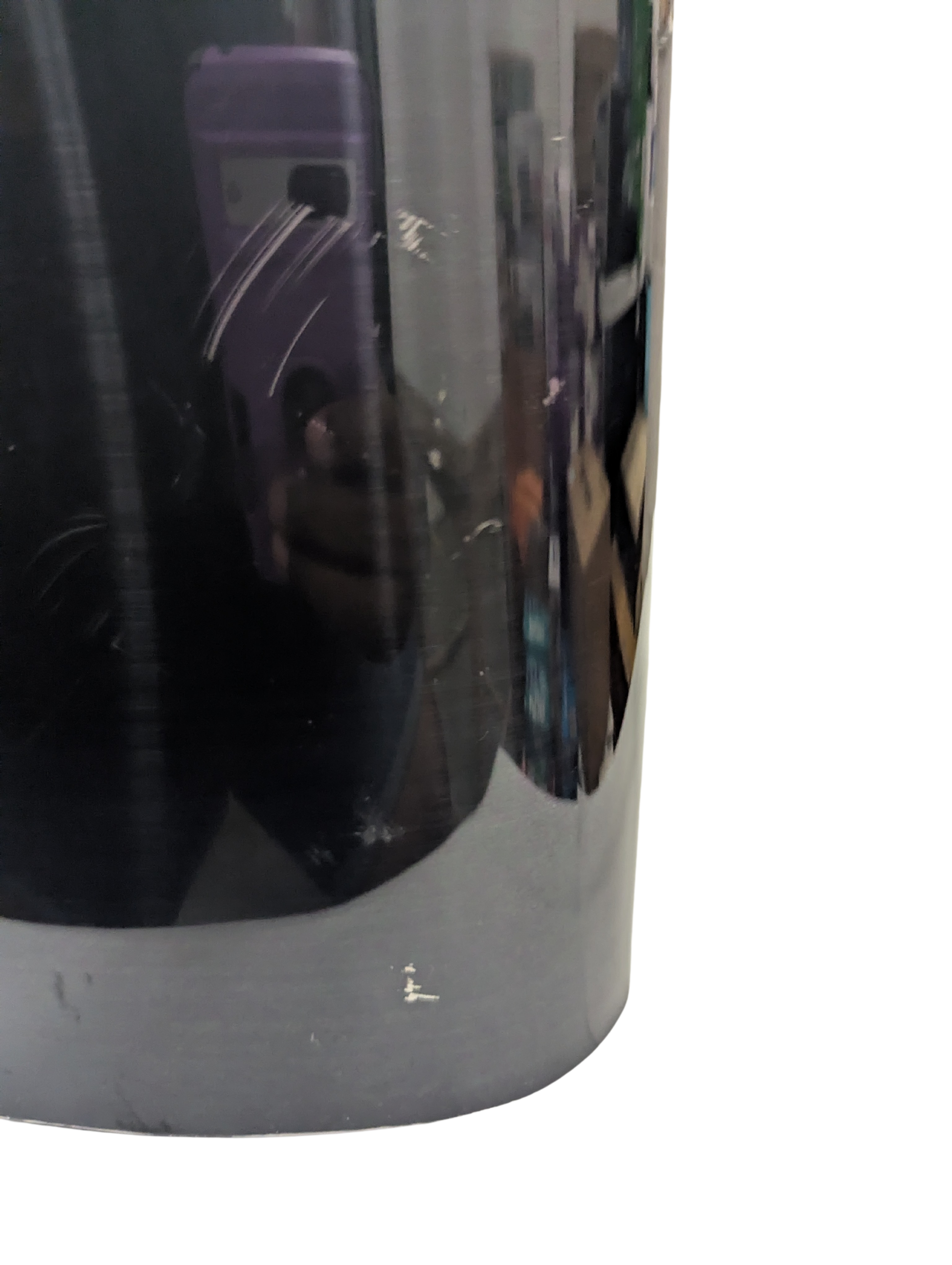 Close-up of a reflective metallic surface with a blurred background