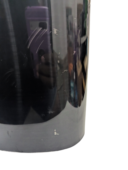 Close-up of a reflective metallic surface with a blurred background