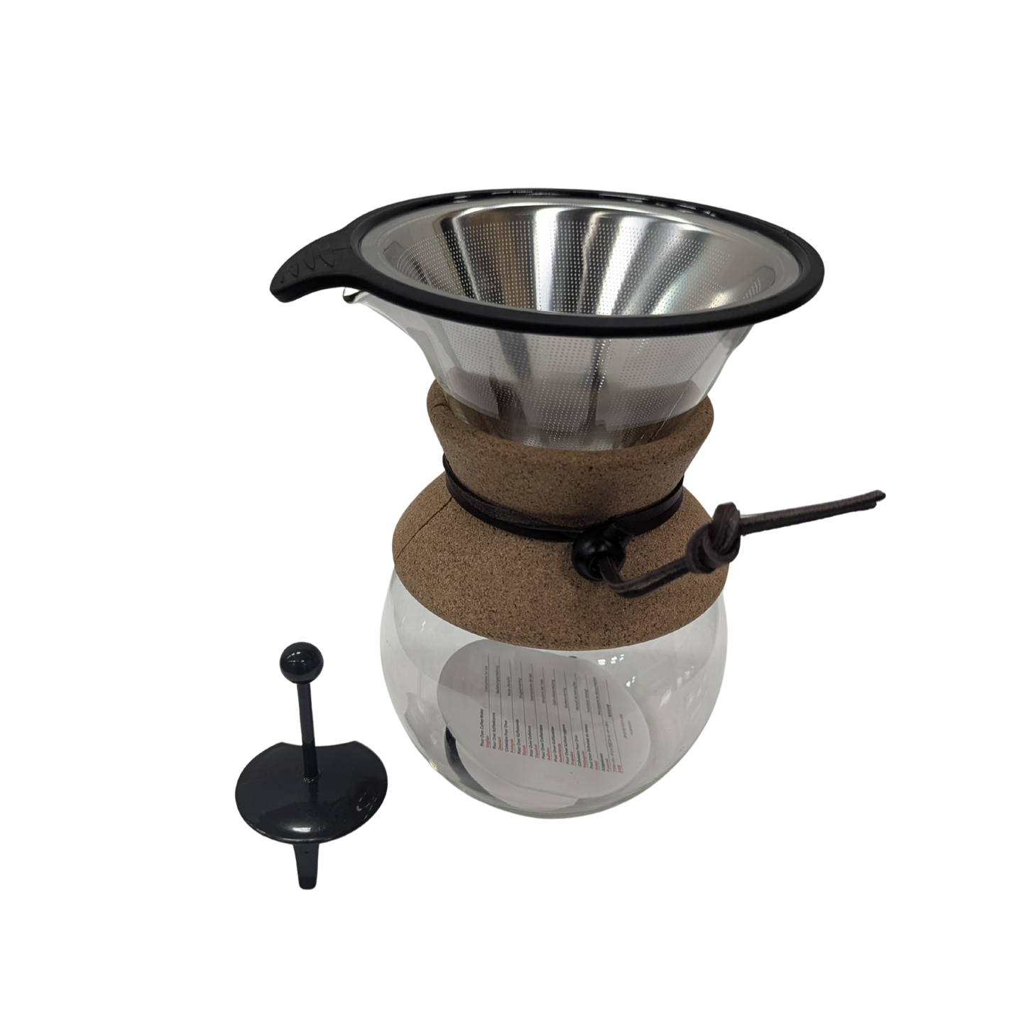 Coffee brewing apparatus with glass carafe and metal filter on a white background