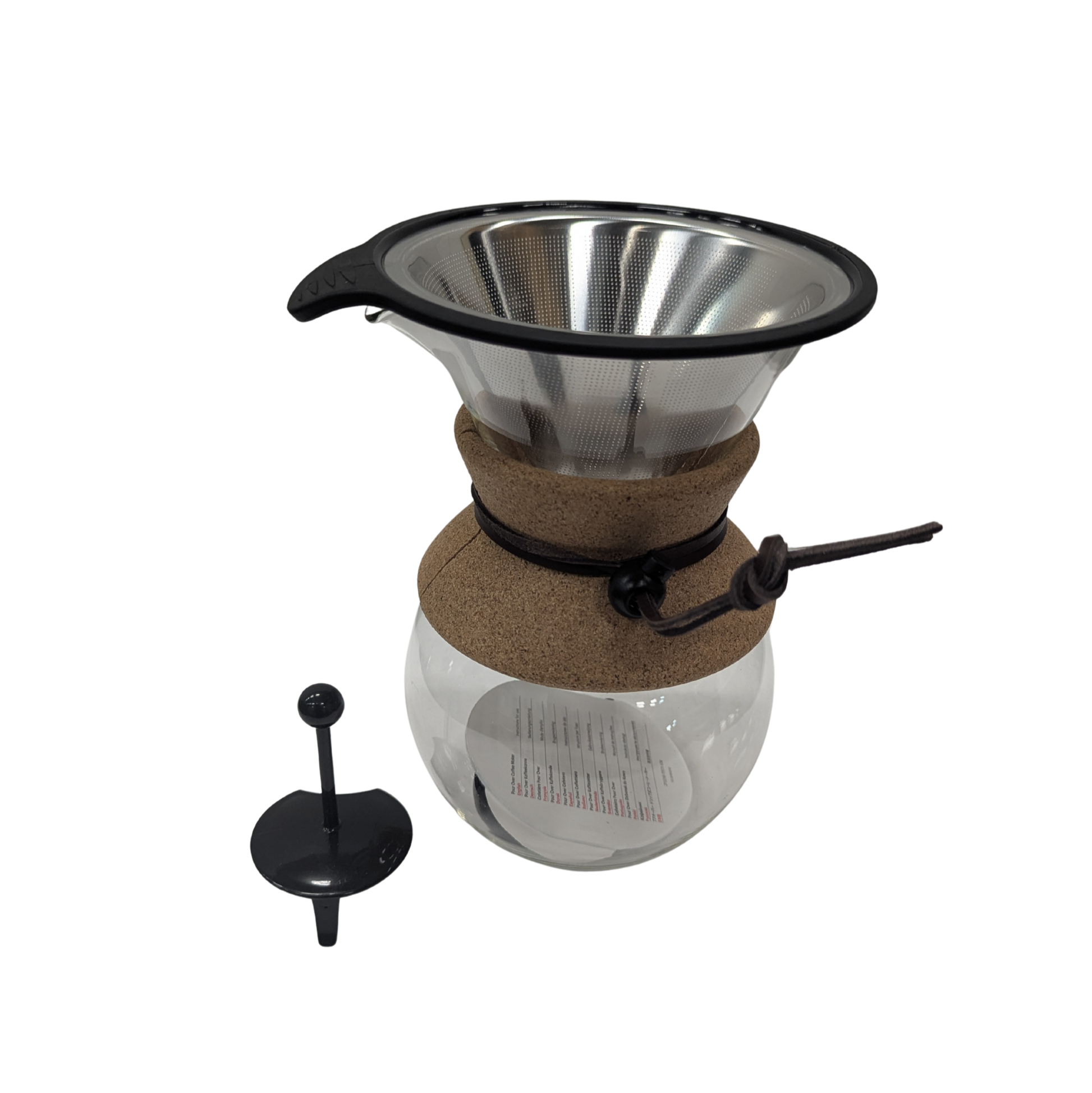 Coffee brewing apparatus with glass carafe and metal filter on a white background