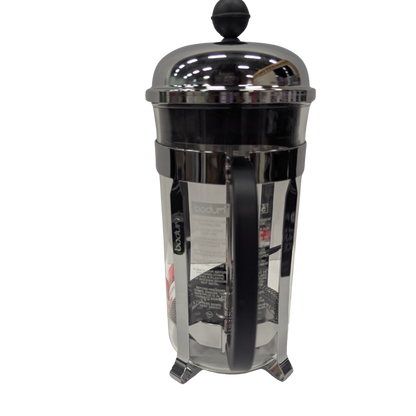 Black and silver French press coffee maker on a white background