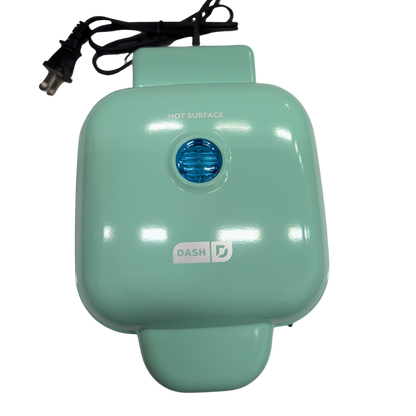 Teal hot surface cooker with blue light indicator on a white background