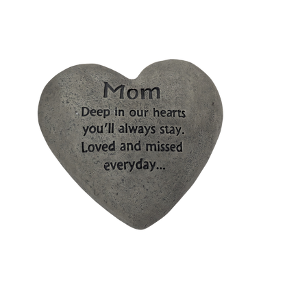 Heart-shaped stone with engraved message for Mom on a white background