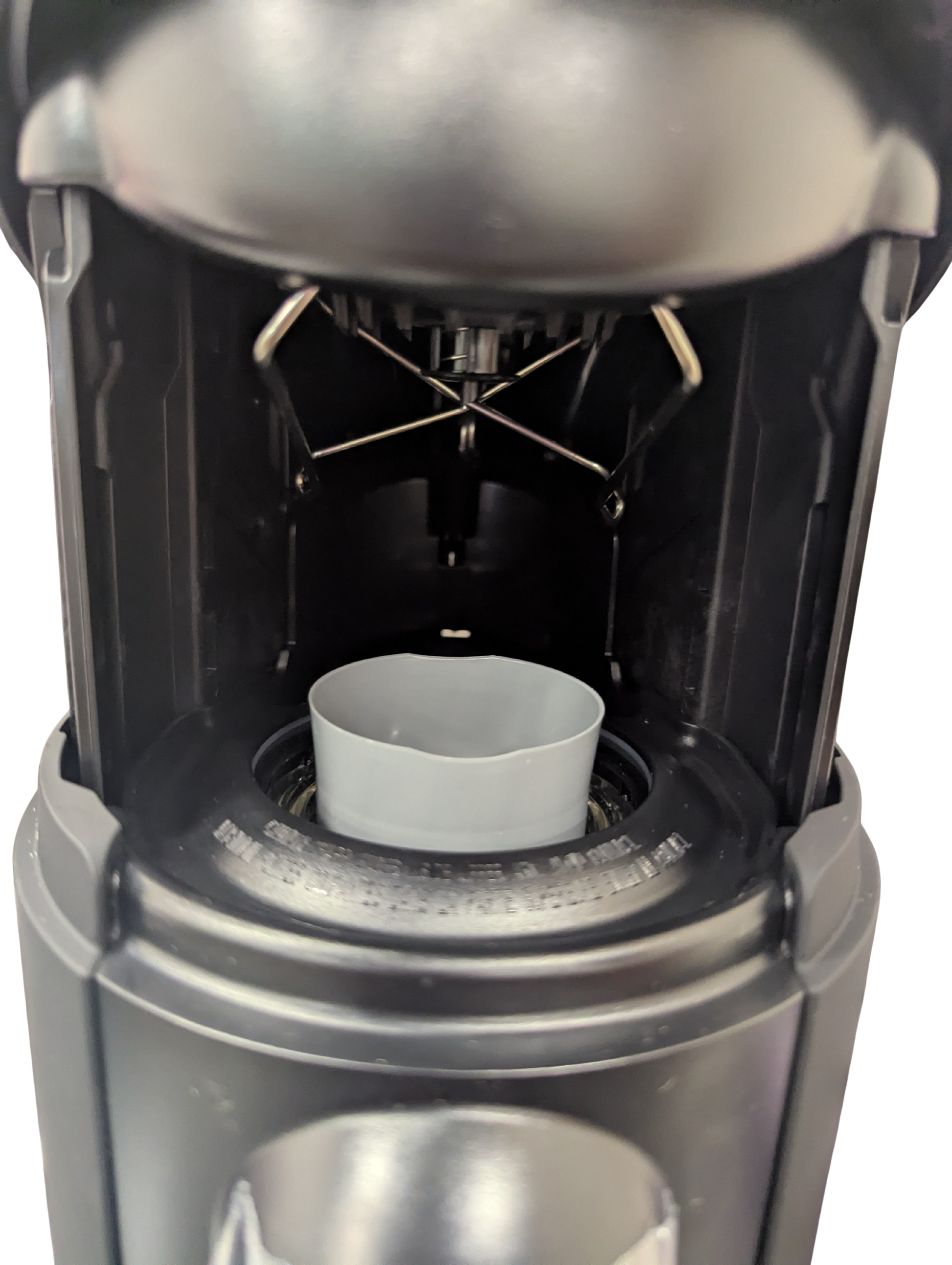 Close-up of a coffee brewing device with a white filter basket.