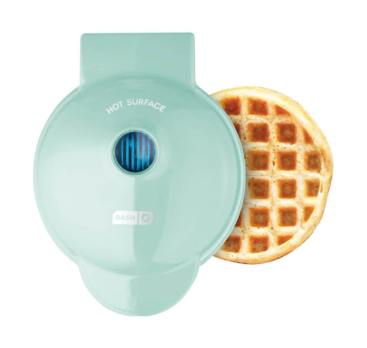 Mint green waffle maker with a cooked waffle on a white background