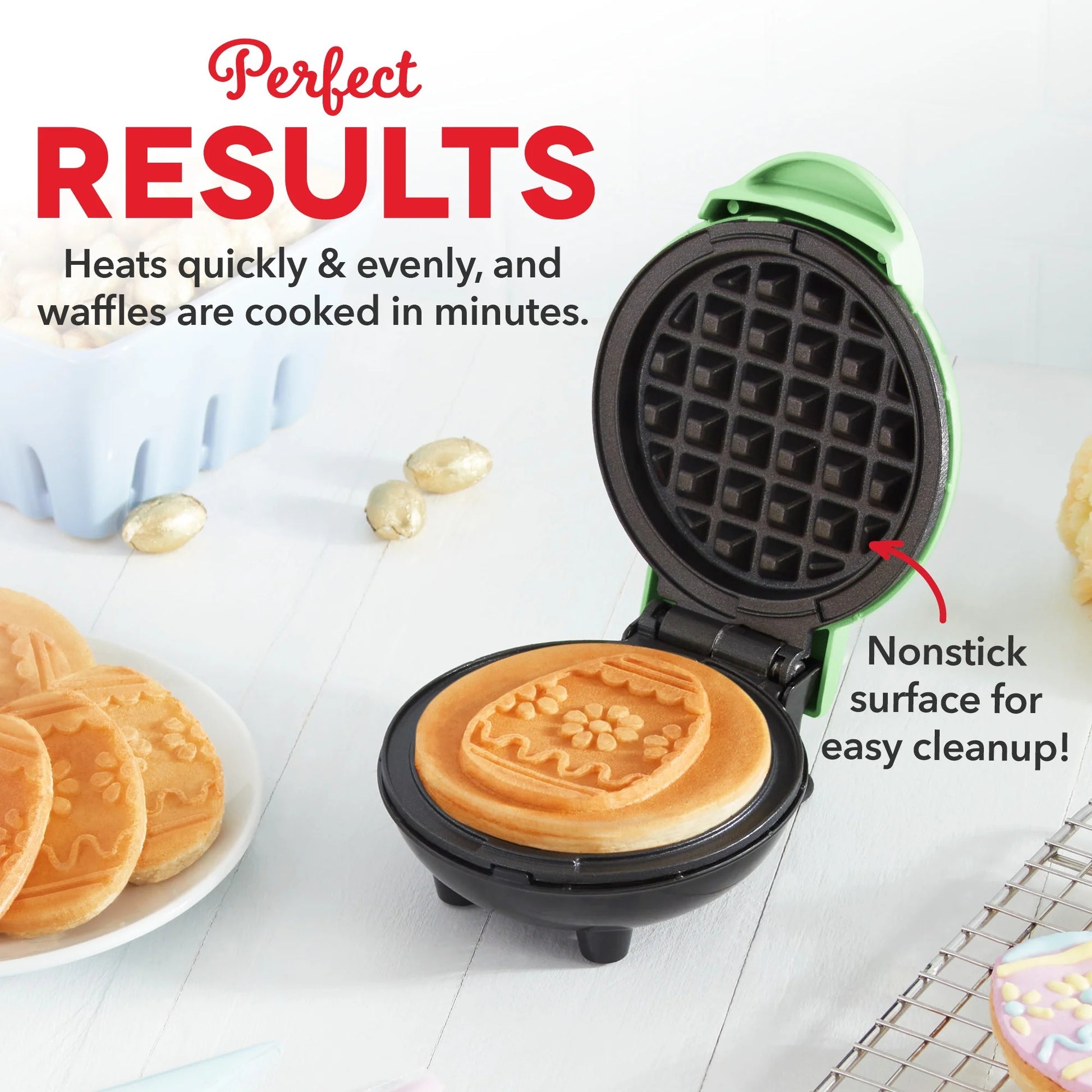 Waffle maker with a cooked waffle inside, surrounded by waffles on a plate and decorative eggs.