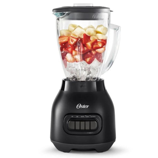 Black Oster blender with a clear container filled with fruits on a white background