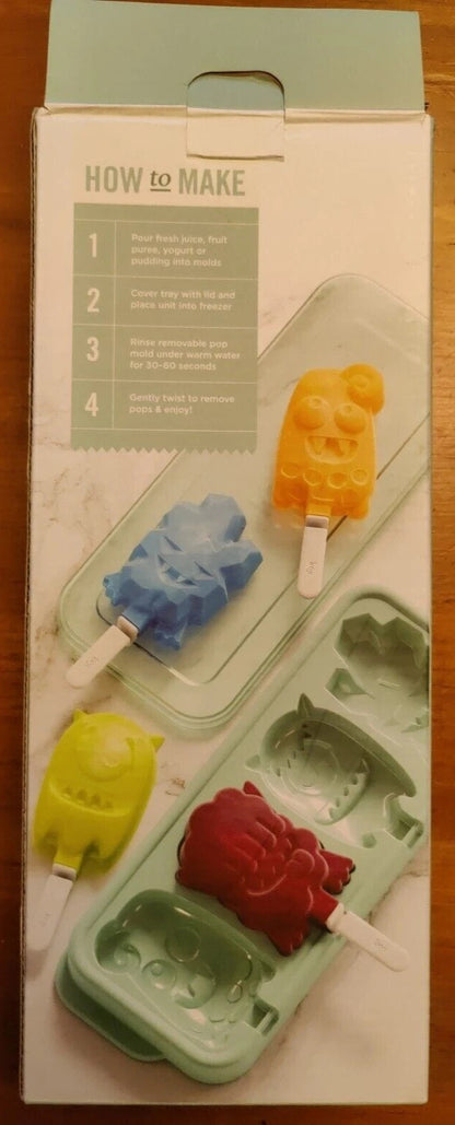 Popsicle mold with colorful popsicles on a wooden surface